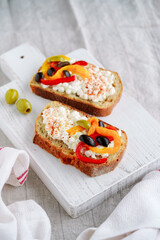 bruschetta with cream cheese and olives and pepper