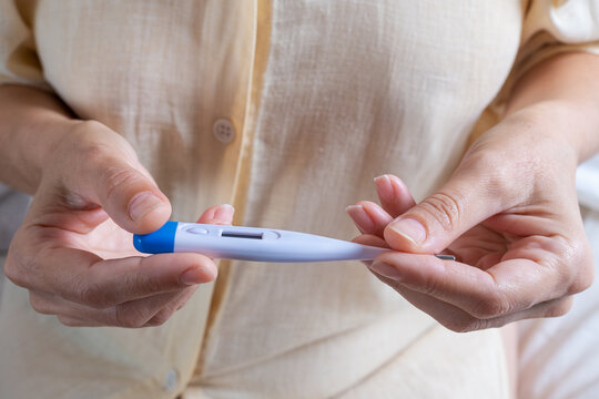 Close up of a woman holding a positive pregnancy test in her hands