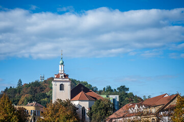 Fototapeta na wymiar Tower of church of St. James with autumn sky - Husovo náměstí, Beroun, Czech Republic