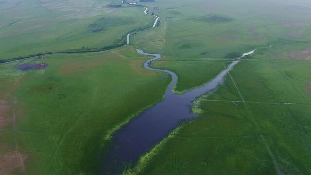 Natural river, Hortobágy canal, Hungary, aerial view. Hortobágy's Quaint River Bend