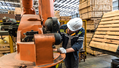 factory engineer working with heavy machine in wood industrial factory
