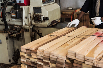 carpenter cutting firewood with electric saw