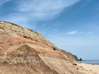 Pink rocky mountains at the ocean coast