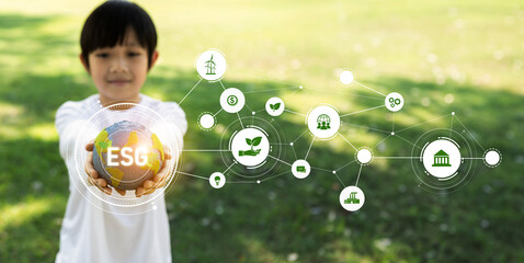 Focused planet Earth globe with eco friendly icon hold by blur little boy, symbolize environmental...