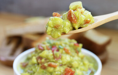 Closeup of Spoon Scooping Delectable Freshly Made Guacamole