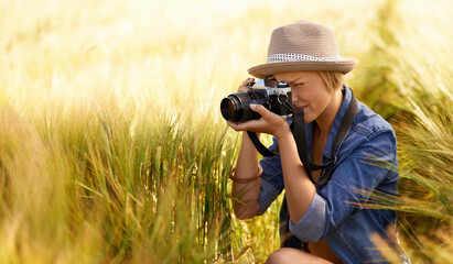 Woman, camera and photography in grass with travel, vacation and holiday with wheat field and...