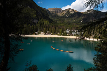Lago di Braies (Pragser Wildsee), stunning alpine lake with beautiful blue color, mountain peaks in...