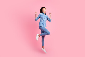 Full length photo of nice lovely glad cheerful girl jumping rising hands up isolated on pink pastel color background