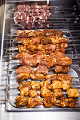 pieces of marinated meat on steel skewers in a Georgian restaurant