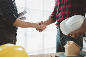 Architects and engineers agree on blueprints together, An agreement is being made regarding the...