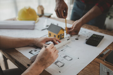 engineer is in planning meeting with architect about building a house,  Draw structural of buildings at the meeting and discuss together,  Design blueprints for use in structural work, architect idea.
