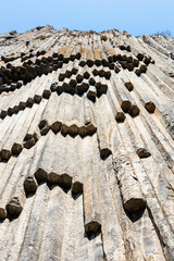 symphony of the stones - bottom view of natural basalt columns close up in Garni gorge in Armenia...