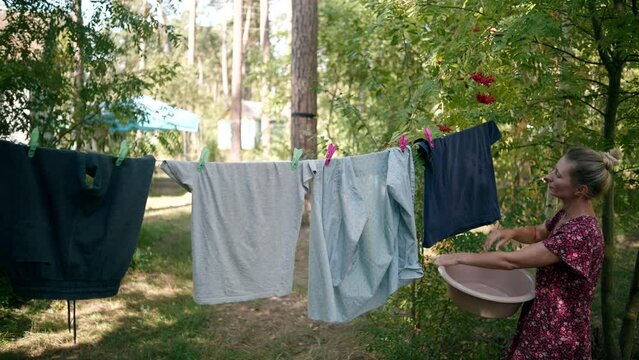 Clothing hangs on clothesline and dries after washing	