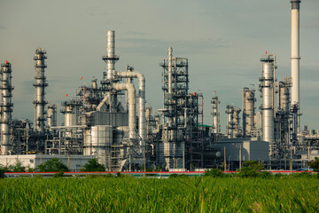 Fototapeta premium Scene evening of tank oil refinery plant tower and column tank oil