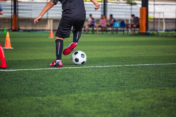 Children playing control soccer ball tactics on grass field with for training