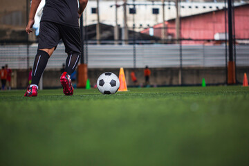 Children playing control soccer ball tactics on grass field with for training