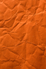 Wrinkled and crumpled orange tissue wrapping paper.