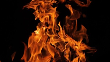 Flames and sparks of fire on a black background. A big bonfire. Fire and danger. Burning wood in the fireplace. Romantic fire. Fire at night.