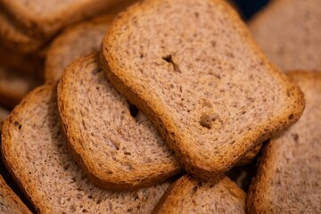 A closeup portrait of a pile of multiple delicious tasty crispy rusk, sea biscuit or hardtack biscuits, ideal food for a lunch, brunch or quick snack with jam or jelly or chocolate spread.