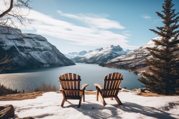 A pair of wooden chairs overlooking lake
