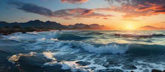 Obraz premium Blue Sea Waves. The sea water is in the shape of a peak. isolated beautiful sunset and clouds in the background
