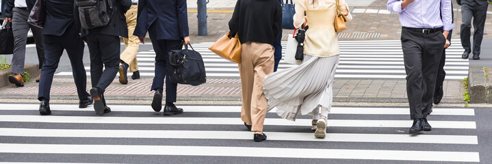 business people crossing a city street in Tokyo, Japan