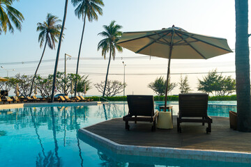 umbrella with bed pool around swimming pool with ocean sea background