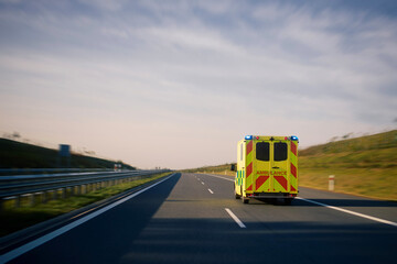 Fast moving ambulance car of emergency medical service on highway. Themes healthcare, rescue and...