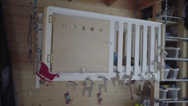 Boy Sleeping In Crib With Reindeer Cardboard Cutouts Hanging At Home - Fairbanks, Alaska