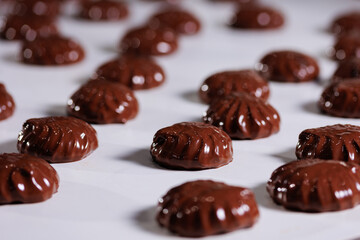 Process of chocolate glazing marshmallows in confectionery on conveyor machine. Automatic line sweet food zephyr factory