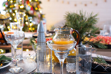Serving a festive table with snacks, salads and goodies close-up in the modern interior of a loft house decorated for Christmas and New Year. Waiting for guests for a festive dinner