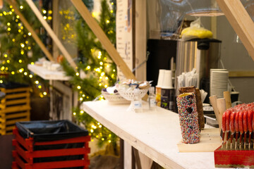 Christmas market in the festive decor of the streets in fairy lights. Exhibition and shopping malls in the city center. New Year, Festive mood