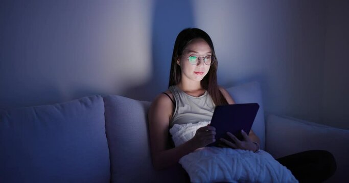 Woman read on tablet computer in the evening