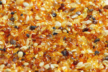 Natural gemstone amber texture background, stones yellow orange gradient color. Natural mineral material for jewelry. Amber textured Aesthetic sunstones wallpaper, pieces ancient resin