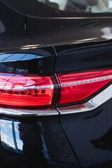 Close up detail on one of the LED taillight modern black car