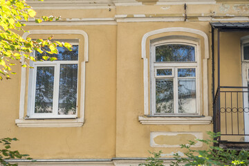 windows with decorative elements on an old wooden or brick building