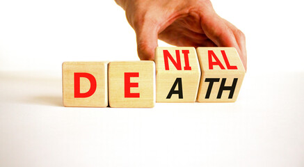 Denial death symbol. Concept words Denial Death on wooden block. Beautiful white table white background. Businessman hand. Business denial death concept. Copy space.