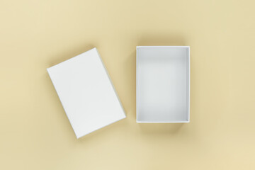 white open cardboard box on a pale yellow background, top view. gift wrapping, delivery concept