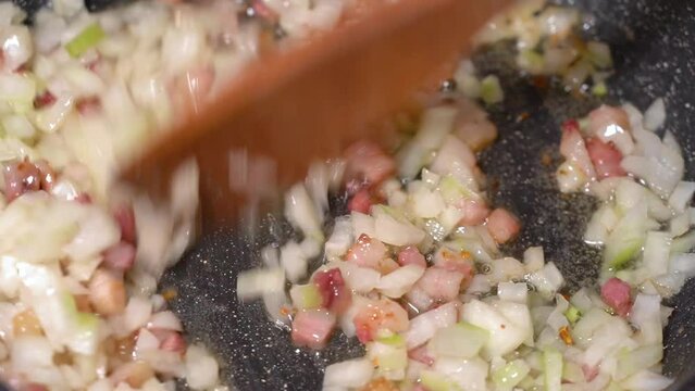 roasting of salted pork fatback with onion on a red-hot pan, close-up	
