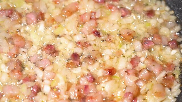 roasting of salted pork fatback with onion on a red-hot pan, close-up	
