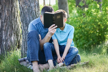 father and child reading the bible