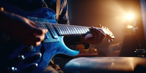 Obraz premium A detailed shot of a person playing a guitar. This image can be used to depict musicians, live performances, music lessons, or the joy of playing a musical instrument.