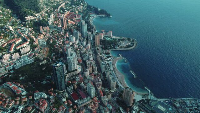 Epic aerial drone shot view of Monaco coast on the Mediterranean sea from the height of a drone flight. Colourful landscape of the cultural center. Top view at sunset. Buildings 