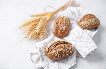 Sesame seeds rye buns on a background