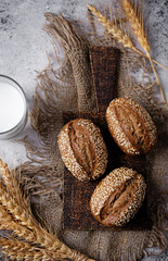 Sesame seeds rye buns on a background