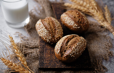 Sesame seeds rye buns on a background