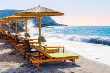 Loung chair on the beach- vacation, travel, relaxation concept