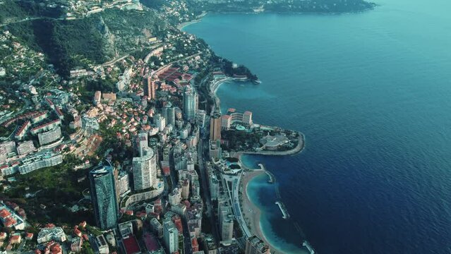 Epic aerial drone shot view of Monaco coast on the Mediterranean sea from the height of a drone flight. Colourful landscape of the cultural center. Top view at sunset. Buildings 