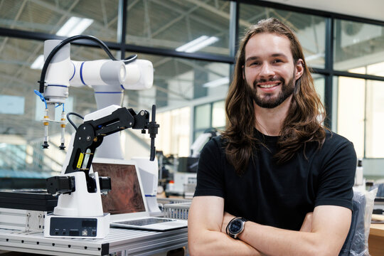 male automation machine engineer student study and inspection control robot machine in university workshop. ai robot technology new innovation trend of manufacturing in industry 5.0