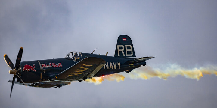 Leszno, Poland - June 16 2023: Antidotum Airshow Leszno 2023 and acrobatic shows full of smoke of Red Bull F4U Corsair on a cloudy sky
